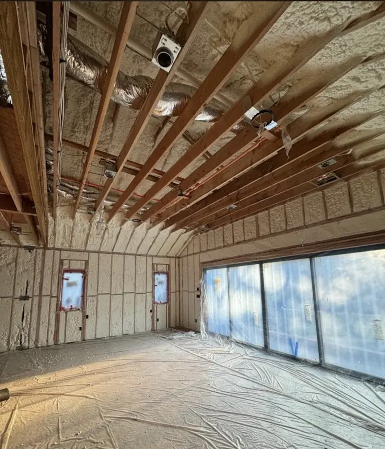 Interior walls and ceiling insulated with spray foam during new construction in Madison